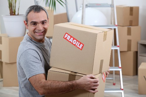 Movers team loading boxes into a moving van