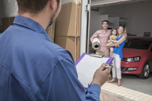 Professional movers carrying belongings down apartment stairs