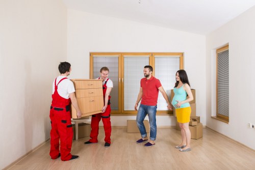 Furniture pick-up service in Watford removing a large sofa from a home