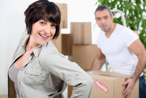 Family moving boxes into storage near Watford