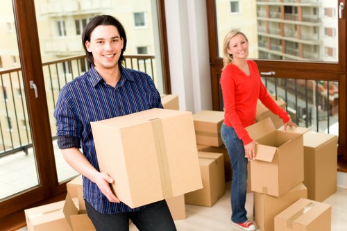 Professional movers using PPE and safety equipment during a move